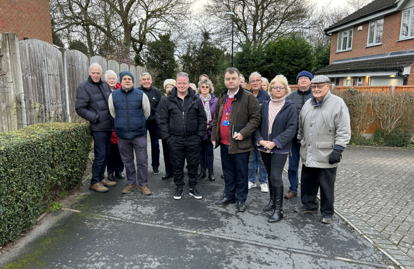 Cllr Gary Ridley (green jacket, centre) next to Cllr Julia Lepoidevin with residents at the narrow site of the proposed access route into the development on High Beech. Cllr Peter Male is second from left.